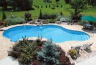 The Canvas:Pure American suburbia, fields of green, a physical challengeThe Palette: Poured concrete cantilever ledges, brick-accented retaining wall, natural field stone waterfeatureThe Masterpiece: Abundant textures, children laughing, a family celebration