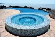 The Canvas:A hidden pool, a hillside home on stilts, a desire to be visibleThe Palette: Perimeter-overflow spa, flagstone deck, rhapsody in blueThe Masterpiece: A radiused curve so graceful it breaks your heart and mends it again in a single second, inspired indulgence, tropical-tinged luxury