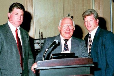 Moment in history: Bill Hanousek, a

founding member of Master Pools Guild, takes the podium at the

group’s 40th anniversary celebration, along with his sons,

Bill Jr. (L) and Steve (R).