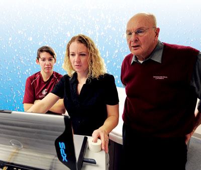 Lab work: Dr. Bruce Becker,

at right, collaborates with members of his research team as they

conduct immersion studies at Washington State

University.