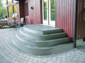 The tiles were butted closely together and installed without grout, allowing water to drain between the tiles and through the fiberglass grating.