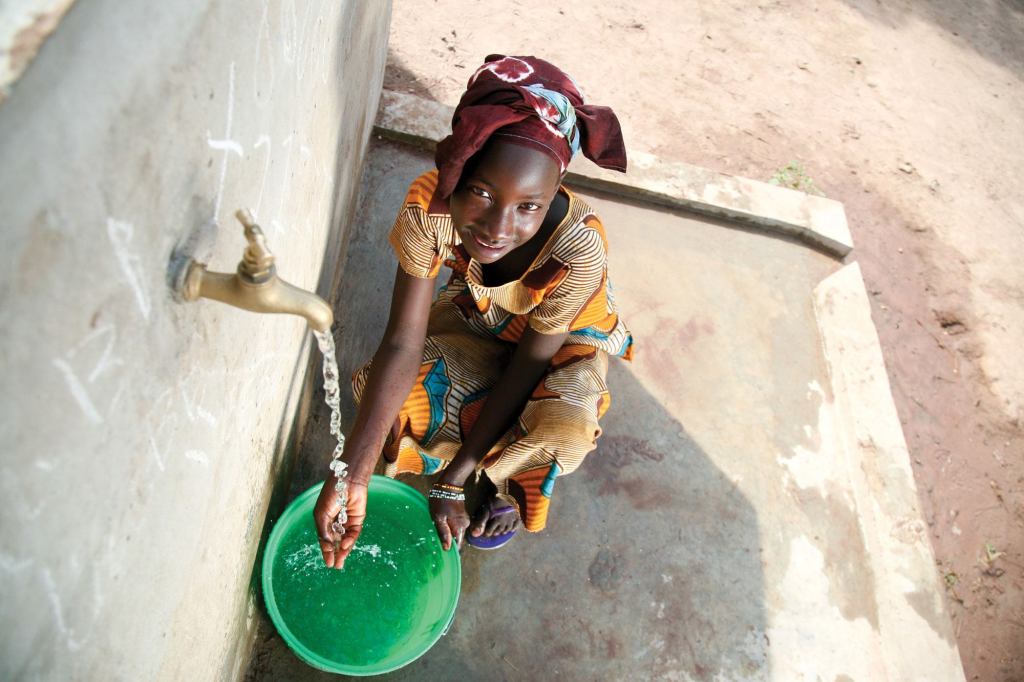 Well off: Before World Vision worked in Kolda, Senegal, this girl and her family had to drink water that was only clean enough to wash pots and pans, and often they became ill. Now her village has one of the 8,700 wells built by World Vision that provides clean drinking water.