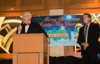 Bill Kent, president/owner of Team Horner, addresses employees at a recent holiday function. In April 2015, he'll step down as president to become chairman of the board. Mike Dooley (right) will succeed him.