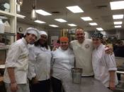 Frank Squeo, owner of Personalized Pool Care in Valley Village, NY, poses with volunteer bakers at BOCES of Rockland County where they'll produce more than 10,000 cookies an hour this holiday season.