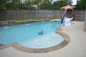The Comeaux's finished pool with an ADA lift that Cody Pools provided free of charge.