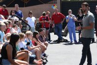 Michael Phelps speaks to approximately 30 children at a pool school held at Presidential Pools in Gilbert, Ariz.