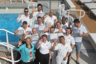 Graduates of a CPO course taught by Connie Sue Centrella (front, far left) gather on the deck of the Azamara Quest in the Greek islands. (photo courtesy C.S. Centrella)