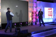 Parker Ewing of Ewing Aquatech Pools plays catch with former MLB pitcher Jim Abbott at UAG's annual meeting in February.