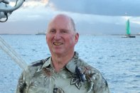 Dick Gross pilots a catamaran in Hawaii.
