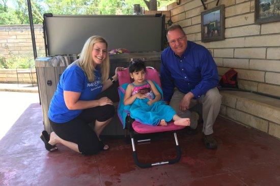 Aubrey and her grandparents pose with their new hot tub.