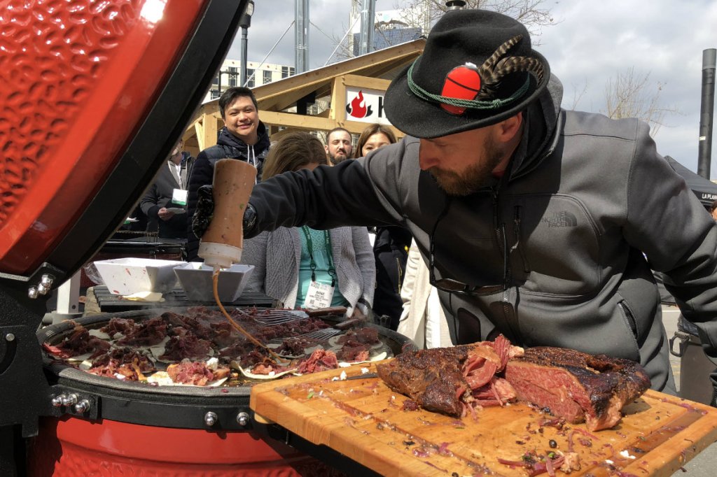 Attendees of the Hearth, Patio & Barbecue Expo in Nashville line up for samples hot off the grill.