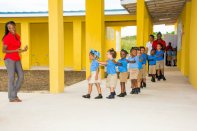 Alixann Campbell, founder and principal of NAZ Children’s Centre, guides students through the campus.
