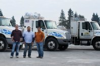 Lee Valenzuela, left, with partners Juan Serrato (center) and Raul Serrato.