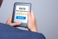 Businessman hands holding tablet with Rate your experience. Business concept.