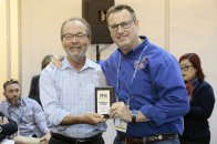 David Hawes, president of the Independent Pool & Spa Association, presents the PSN Jandy Top 50 Service Award to Gary Crayton III, CEO of Pool Troopers, which topped the list.