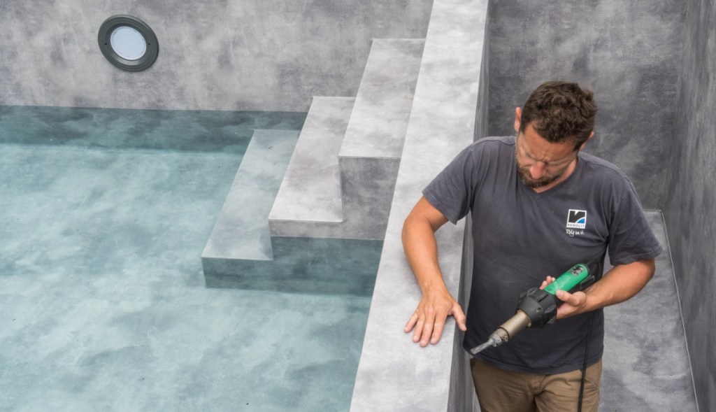 An installer easily welded-in the designer PVC membrane to create the pool’s natural stone-like finish