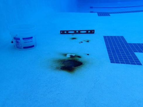 Before: A municipal pool undergoes a rebar repair operation. The rust
 stain shown in the top photo only hints at the extent of damage under 
the shell.