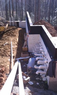 This shows the plumbing going into the equipment room, which is in the basement of the guest house. We have 4-inch pipes for most of the suctions and returns. The lines run about 80 feet to the pool.