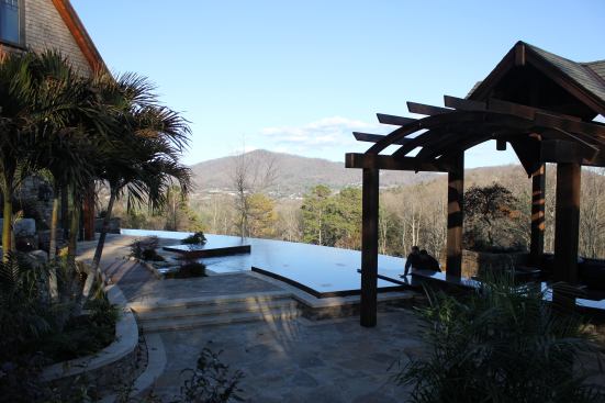 Oftentimes, outdoor kitchens are integrated into the poolscape, so the chef can easily chat with others in the backyard. In this case, however, Dorsey wanted the opposite. The wealthy homeowners generally don’t do their own cooking, but have a staff that prepares meals for them. “So it becomes more like a commercial application, where you have, say, a swim-up bar at a resort,” Dorsey explains. The kitchen features a sunken floor, allowing guests to see over the bartender and enjoy the hillside view.