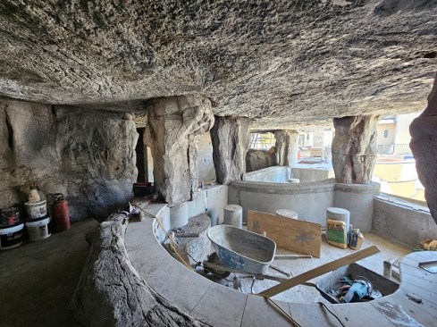 A grotto under construction, with the swim-up spa in the foreground.