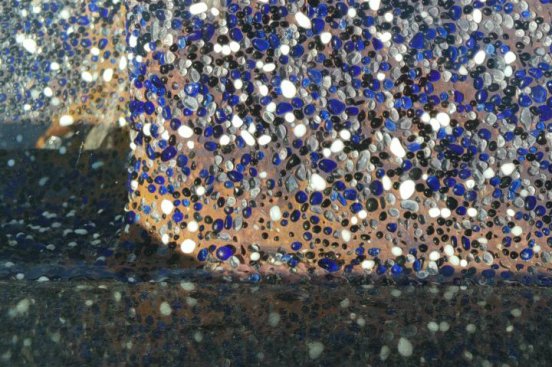 While the blue aggregate muted it somewhat, the cement binder between the beads and pebbles had turned a brick red.