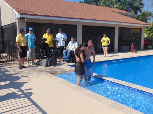 With the help of his wife, Avilez walks down the special entry ramp and into his new pool for the first time.
