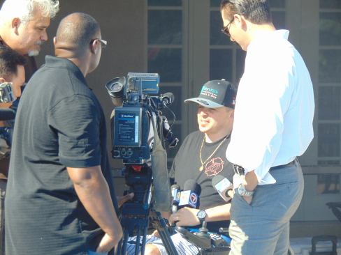 Avilez dons a Van Kirk & Sons hat while being interviewed by local media during the construction of his pool.