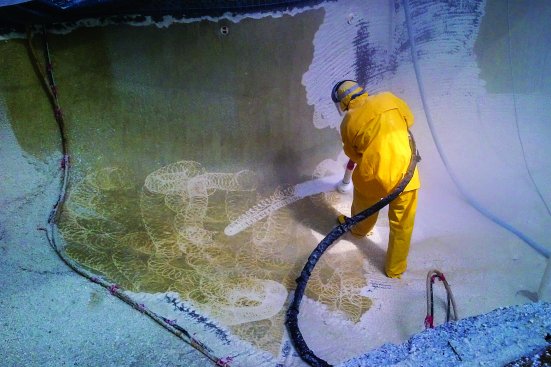 Crews gear up for safety by wearing a rain suit and head gear when they water jet.