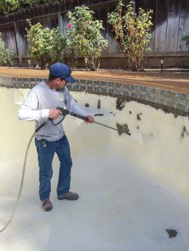 From the bottom up: Preparation is key to a good bond coat. A pro from New Image Pool Interiors in Fresno, Calif., sandblasts the surface to remove the top layer and roughen it up. 