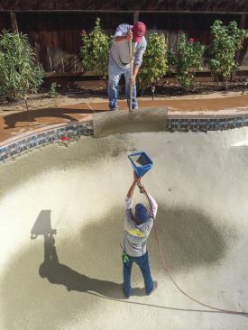 Right technique: Spraying the bond coat material is pricier because of the equipment investment, but it also helps assure the right, stippled texture for proper adhesion of the finish coat. Above, while applying the bond coat material, crews hold the hopper gun perpendicular to the surface to assure the most material will stick. Otherwise, it will hit the substrate at an angle and some will bounce off. The compressor should be adjusted to release the right amount of air.