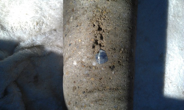 These photos show shadowing, in which shotcrete fails to properly 
compact behind the rebar. Here the concrete is not monolithic in the 
space behind the steel.