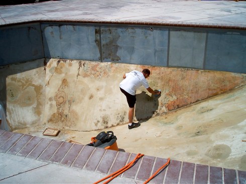 Begin by scraping off and removing all debris and filling in all cracks.  