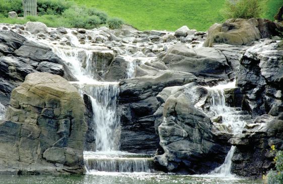 Best practices: This waterfeature exhibits natural-appearing surfaces and flow. Water moves between stones and through apparently eroded pathways.