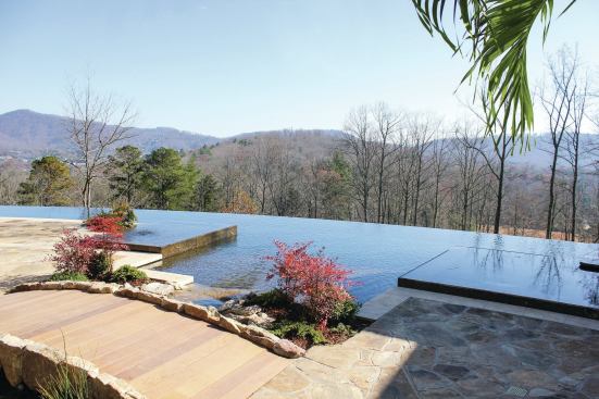 Eye for symmetry: Flanking the point where water enters the pool from the stream are two square, perimeter-overflow vessels. On the right sits a spa. For symmetry’s sake, Dorsey mirrored the spa with a perimeter-overflow sun shelf on the opposite side of the stairs. Having the vessels spill over on all sides and sit only 6 inches above water level made the pool seem more full.