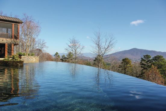 The design team chose to cap the vanishing edge weir with a fossilized marble from Morocco. The warm tones and embedded fossils echo the modern and rustic feel of the house; however, the material is not the most durable for enduring freeze/thaw conditions. For this reason, the team obtained extra stone with the intent of replacing pieces down the line. The material also veneers the raised perimeter sun shelf (not shown).