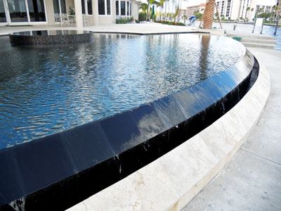 Angled Beam Vanishing Edge: This project (above), designed by Aquatic Consultants, features an angled beam detail. (See diagram.) Also designed by Aquatic Consultants, this project (below) combines both

the radius-wall overflow with an elevated perimeter overflow detail. Additionally, the granite-finished exterior riser is canted in a reverse pyramidal detail, allowing the water to cline to it into the slot overflow.