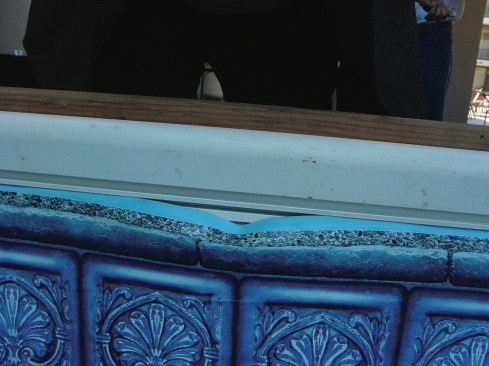 1. The weight of the water has caused a small part of the liner to sag. When the liner bead pops loose from the track, it resembles a grin. 