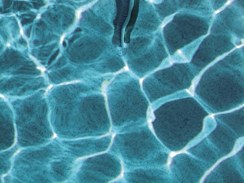 4. Once the patch is where it’s needed, put pressure on it by pushing down on the brush. This holds it in place until it’s dry, and it also helps smooth out any wrinkles.