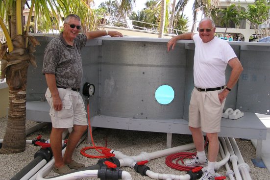 Don Witte (left), with frequent collaborator William Rowley at a test pool built on Witte's property.